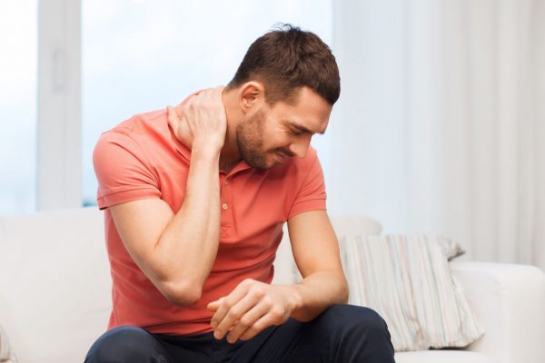 stock-photo-unhappy-man-suffering-from-neck-pain-at-home-370613375-smaller-600x400
